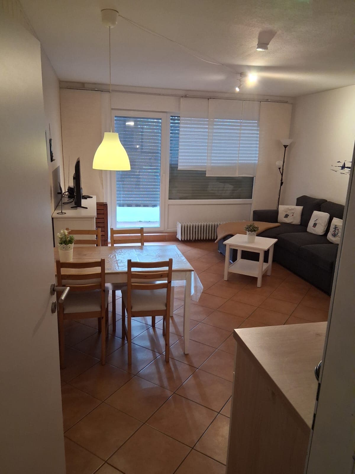 Wohn- und Essbereich mit Esstisch, Ecksofa und Fernseher